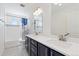 Bright bathroom featuring dual sinks, modern fixtures, and a shower-tub combo for a refreshing experience at 11033 Olathe St, Commerce City, CO 80022
