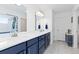 Bright bathroom featuring dual sinks, modern fixtures, and a glass shower for a refreshing experience at 11033 Olathe St, Commerce City, CO 80022
