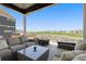 Inviting covered patio with comfortable seating and views of a green space and neighborhood at 11033 Olathe St, Commerce City, CO 80022