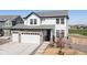 Charming two-story home with a stone and siding exterior and a two car attached garage at 11033 Olathe St, Commerce City, CO 80022