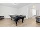 Spacious game room with a black pool table set up for play on top of wood floors at 11033 Olathe St, Commerce City, CO 80022