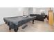 Game room showing a pool table with cover, leading to more entertainment space in the home at 11033 Olathe St, Commerce City, CO 80022