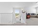 Upstairs hallway features white railing and a view of the living room at 11033 Olathe St, Commerce City, CO 80022
