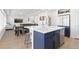 Open concept kitchen features navy island with sink, barstool seating, and stainless steel appliances at 11033 Olathe St, Commerce City, CO 80022