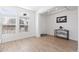 Bright living room boasts hardwood floors, large windows, and neutral walls at 11033 Olathe St, Commerce City, CO 80022