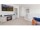 Cozy loft area featuring a fireplace, television, and comfortable seating with a staircase to the upper level at 11033 Olathe St, Commerce City, CO 80022