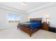 Spacious primary bedroom featuring a tray ceiling, large window, and a storage bed at 11033 Olathe St, Commerce City, CO 80022