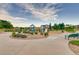 Community playground with various play structures and equipment, surrounded by trees and landscaping at 11033 Olathe St, Commerce City, CO 80022