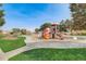 Colorful playground equipment with slides, swings, and climbing structures in a well maintained community park at 11033 Olathe St, Commerce City, CO 80022