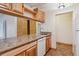 Kitchen view featuring wooden cabinets, granite countertops, and a stainless steel sink at 675 S University Blvd # 205, Denver, CO 80209