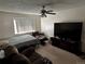 Comfortable bedroom setup with a TV, bed, fan and seating area at 1511 Belero St, Broomfield, CO 80020