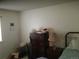 Modest bedroom with dresser, nightstand, lamp, and bed frame at 1511 Belero St, Broomfield, CO 80020