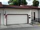 Exterior view of home featuring a two-car garage, red-tiled roof, and American flag at 1511 Belero St, Broomfield, CO 80020