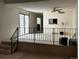 Living room with steps leading to another level and sliding door to a patio at 1511 Belero St, Broomfield, CO 80020