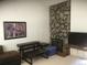 Bright living room featuring a stone fireplace, neutral carpet, and television at 1511 Belero St, Broomfield, CO 80020