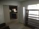 Bright room showcasing a window and view to a kitchen with wooden cabinets at 1511 Belero St, Broomfield, CO 80020