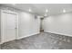 Finished basement area with neutral carpet, recessed lighting, and doorways at 1866 Sawtooth Mountain Dr, Berthoud, CO 80513