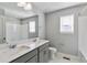 Bathroom features a double vanity sink and a combined shower and bathtub at 1866 Sawtooth Mountain Dr, Berthoud, CO 80513