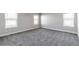 A spacious bedroom offers a soft carpet and large windows at 1866 Sawtooth Mountain Dr, Berthoud, CO 80513