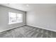 Well-lit bedroom offering a serene atmosphere with a large window overlooking the neighborhood at 1866 Sawtooth Mountain Dr, Berthoud, CO 80513