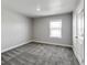 This bedroom has carpeted floors, a window for natural light, and a door for entry/exit at 1866 Sawtooth Mountain Dr, Berthoud, CO 80513