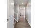 Inviting hallway with neutral paint, white trim, and wood-look flooring leads to other rooms, and an upper level at 1866 Sawtooth Mountain Dr, Berthoud, CO 80513