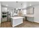 Well-equipped kitchen with grey cabinets, stainless steel appliances, pendant lighting, island, and wood floors at 1866 Sawtooth Mountain Dr, Berthoud, CO 80513
