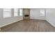 Bright living room showcases wood floors, a stylish fireplace, and multiple windows for natural light at 1866 Sawtooth Mountain Dr, Berthoud, CO 80513