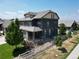 Lovely aerial perspective of a home featuring a well-kept lawn, classic architecture, and a white fence at 90 Pipit Lake Way, Erie, CO 80516