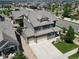 Beautiful aerial shot of a home showcasing a well-maintained roof, spacious driveway, and lush green lawn at 90 Pipit Lake Way, Erie, CO 80516