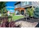 Backyard view featuring a pergola-covered patio, landscaping, and attractive trees at 90 Pipit Lake Way, Erie, CO 80516