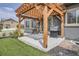 Relaxing outdoor patio space with a pergola, grill, and adjacent lawn, ideal for entertaining at 90 Pipit Lake Way, Erie, CO 80516
