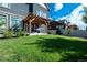 Backyard with lush green grass, a patio with pergola, and a privacy fence at 90 Pipit Lake Way, Erie, CO 80516