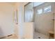 Modern tiled shower with a built-in bench and a glass enclosure at 90 Pipit Lake Way, Erie, CO 80516