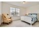 Bright bedroom with a large window, plush carpet, and a cozy armchair at 90 Pipit Lake Way, Erie, CO 80516