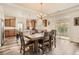 Inviting dining area with wood floors, stylish lighting, and access to the backyard at 90 Pipit Lake Way, Erie, CO 80516