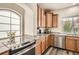Well-equipped kitchen with granite counters, wooden cabinets, and stainless steel appliances at 90 Pipit Lake Way, Erie, CO 80516