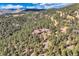 Panoramic aerial view of mountain home nestled in a lush forest with a scenic backdrop at 135 Poorman Rd Rd, Boulder, CO 80302