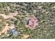 Aerial view from above of a mountain home nestled among trees on a hillside at 135 Poorman Rd Rd, Boulder, CO 80302