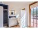 Bathroom featuring tiled shower, vanity, toilet, and access to deck at 135 Poorman Rd Rd, Boulder, CO 80302