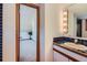 Retro bathroom and closet features classic blue tiling, vintage light fixtures, and closet storage at 135 Poorman Rd Rd, Boulder, CO 80302