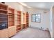 Bedroom with custom wood shelving and large window view at 135 Poorman Rd Rd, Boulder, CO 80302