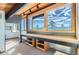 Sunlit bonus room features custom built-in desk and shelving and breathtaking mountain views at 135 Poorman Rd Rd, Boulder, CO 80302