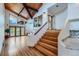 Elegant foyer featuring a staircase, hardwood floors, and a vaulted ceiling with unique architectural details at 135 Poorman Rd Rd, Boulder, CO 80302