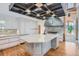 Modern kitchen boasts a center island with stone countertops, custom cabinetry, and professional-grade appliances at 135 Poorman Rd Rd, Boulder, CO 80302