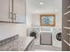 Convenient laundry room with washer, dryer, utility sink, and storage cabinets at 135 Poorman Rd Rd, Boulder, CO 80302