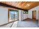 Bright living room with wood ceiling, balcony access, and neutral carpet at 135 Poorman Rd Rd, Boulder, CO 80302