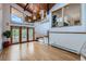 Open living room with wood floors, unique lighting fixture, and natural light at 135 Poorman Rd Rd, Boulder, CO 80302