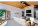 Bright living room featuring wood ceilings, a white brick fireplace, and access to an outdoor space at 135 Poorman Rd Rd, Boulder, CO 80302