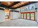 The living room features wood ceilings, deck access, mountain views, and leads into a nearby kitchen at 135 Poorman Rd Rd, Boulder, CO 80302